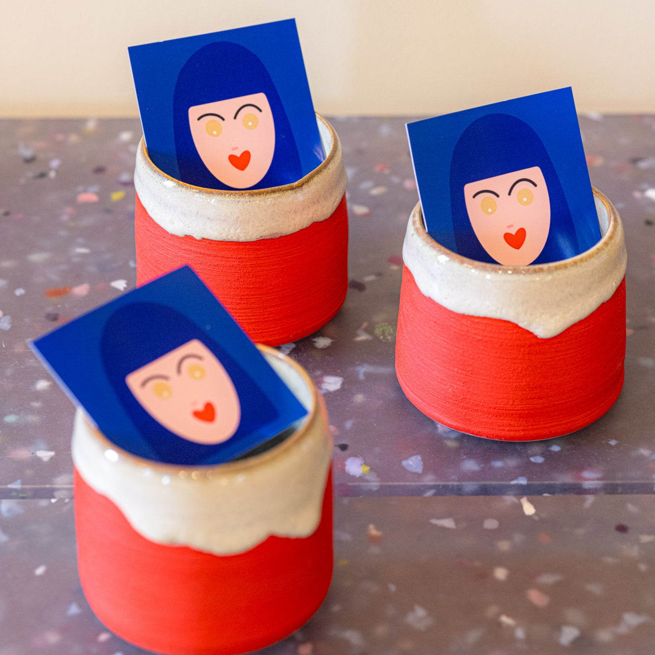 Three colorful cups with textured glaze artisan made.